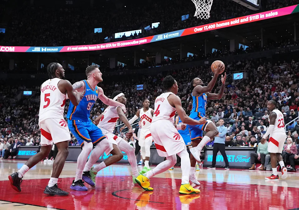 Feb 24, 2026; Toronto, Ontario, CAN; Oklahoma City Thunder guard Cason Wallace (22) drives to the basket against Toronto Raptors forward Scottie Barnes (4) during the fourth quarter at Scotiabank Arena. Mandatory Credit: Nick Turchiaro-Imagn Images