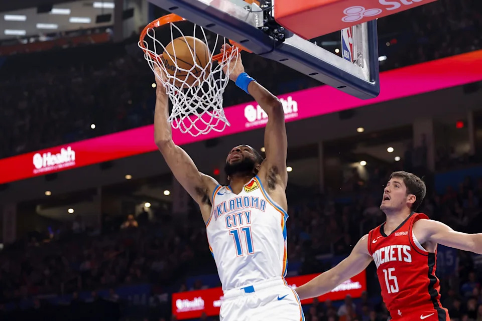 Feb 7, 2026; Oklahoma City, Oklahoma, USA; Oklahoma City Thunder guard Isaiah Joe (11) dunks in front of Houston Rockets guard Reed Sheppard (15) during the first half at Paycom Center. Mandatory Credit: Alonzo Adams-Imagn Images