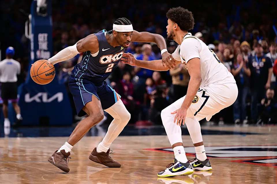 OKLAHOMA CITY, OKLAHOMA - FEBRUARY 27: Shai Gilgeous-Alexander #2 of the Oklahoma City Thunder handles the ball in front of Cameron Johnson #23 of the Denver Nuggets during the second half at Paycom Center on February 27, 2026 in Oklahoma City, Oklahoma. NOTE TO USER: User expressly acknowledges and agrees that, by downloading and or using this photograph, User is consenting to the terms and conditions of the Getty Images License Agreement. (Photo by Joshua Gateley/Getty Images)