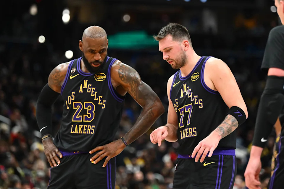 Los Angeles Lakers forward/guard Luka Doncic (77) talks with Los Angeles Lakers forward LeBron James (23) against the Washington Wizards during the second half at Capital One Arena.Brad Mills-Imagn Images