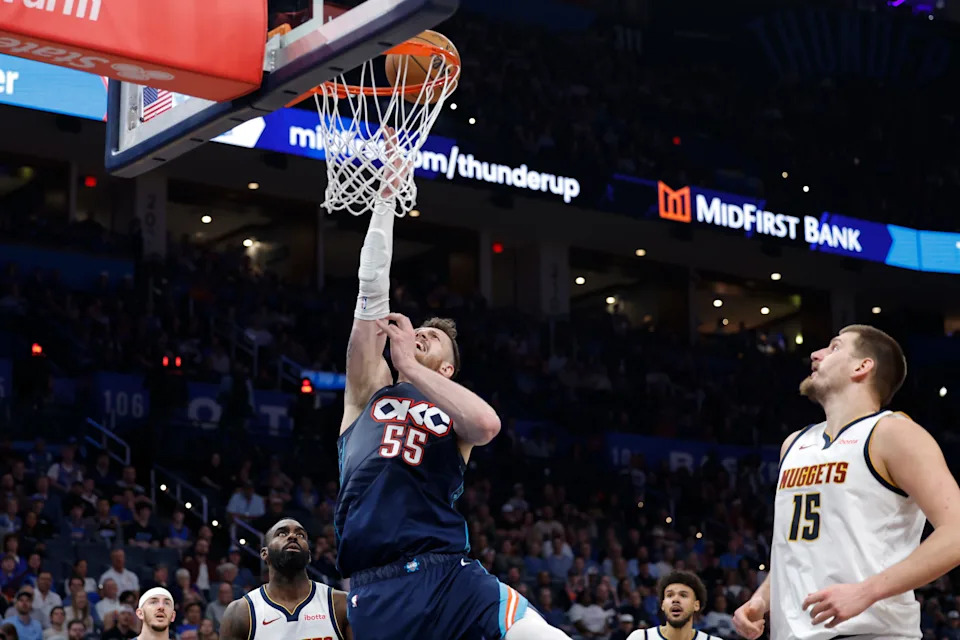 Feb 27, 2026; Oklahoma City, Oklahoma, USA; Oklahoma City Thunder center/forward Isaiah Hartenstein (55) goes up for a basket as Denver Nuggets center Nikola Jokić (15) looks on during the third quarter at Paycom Center. Mandatory Credit: Alonzo Adams-Imagn Images