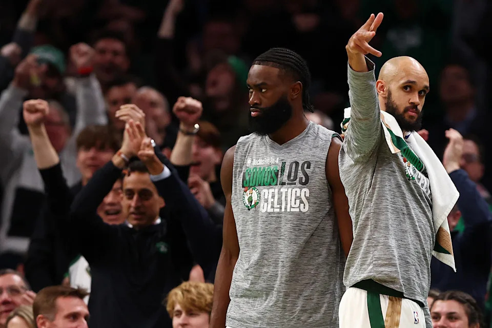 BOSTON, MASSACHUSETTS - MARCH 14: Derrick White #9 and Jaylen Brown #7 of the Boston Celtics reacts after the Celtics scored against the Phoenix Suns during the first quarter at TD Garden on March 14, 2024 in Boston, Massachusetts. NOTE TO USER: User expressly acknowledges and agrees that, by downloading and or using this photograph, user is consenting to the terms and conditions of the Getty Images License Agreement. (Photo by Maddie Meyer/Getty Images)