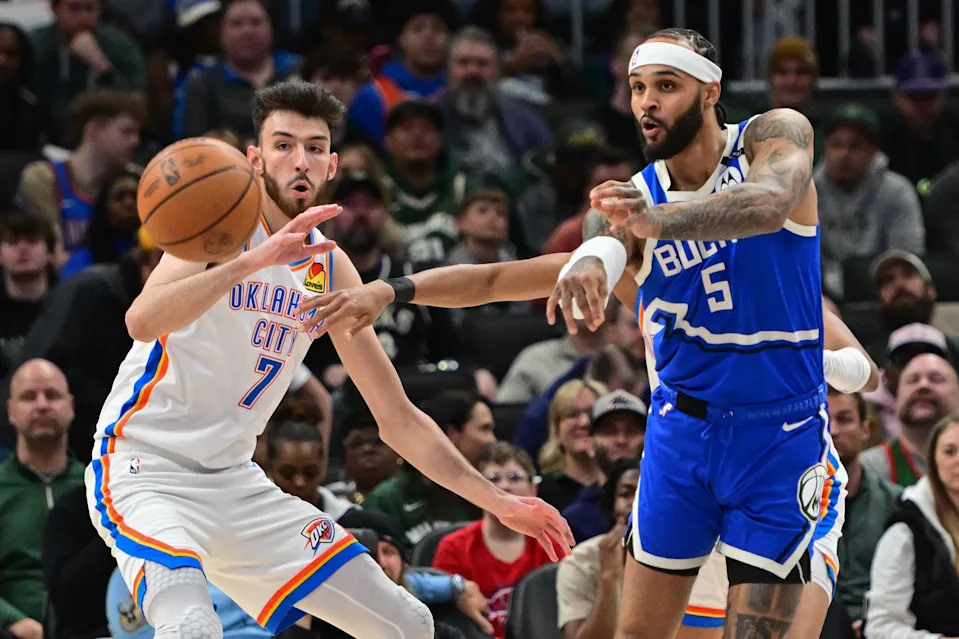Mar 16, 2025; Milwaukee, Wisconsin, USA; Milwaukee Bucks guard Gary Trent Jr. (5) passes the ball away from Oklahoma City Thunder center Chet Holmgren (7) in the second quarter at Fiserv Forum. Mandatory Credit: Benny Sieu-Imagn Images