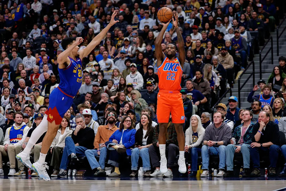 Feb 1, 2026; Denver, Colorado, USA; Oklahoma City Thunder guard Cason Wallace (22) attempts a shot as Denver Nuggets forward Spencer Jones (21) defends in the first quarter at Ball Arena. Mandatory Credit: Isaiah J. Downing-Imagn Images