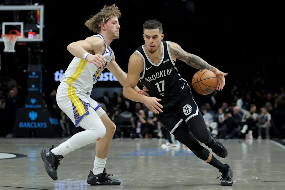 Dec 29, 2025; Brooklyn, New York, USA; Brooklyn Nets forward Michael Porter Jr. (17) drives to the basket against Golden State Warriors guard Brandin Podziemski (2) during the third quarter at Barclays Center. Mandatory Credit: Brad Penner-Imagn Images