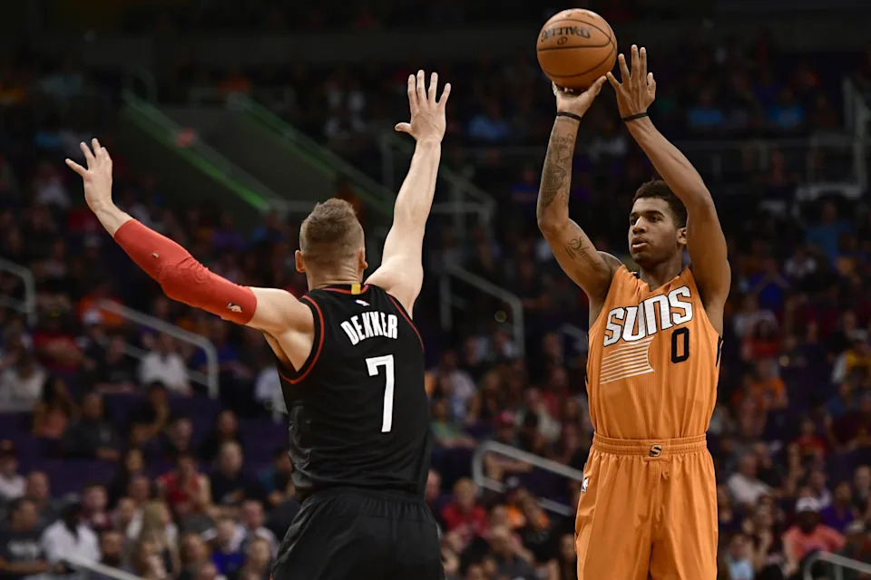 Apr 2, 2017; Phoenix, AZ, USA; Phoenix Suns forward Marquese Chriss (0) shoots over Houston Rockets forward Sam Dekker (7) during the first half at Talking Stick Resort Arena. Mandatory Credit: Joe Camporeale-USA TODAY Sports