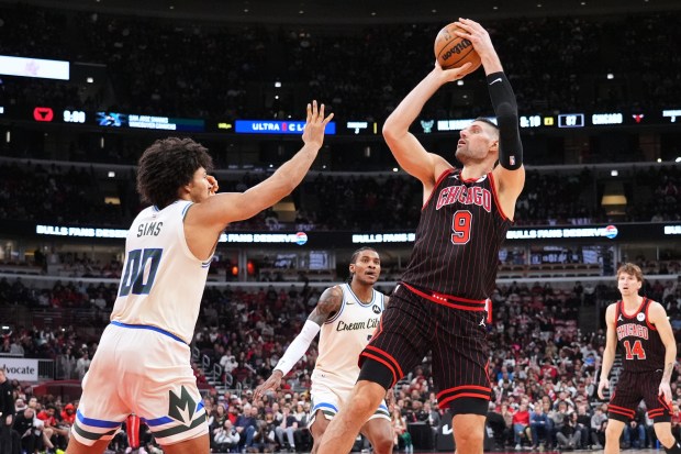 Chicago Bulls center Nikola Vucevic (9) shoots against Milwaukee Bucks center Jericho Sims (00) during the second half of an NBA game in Chicago, Saturday, Dec. 27, 2025. (AP Photo/Nam Y. Huh)