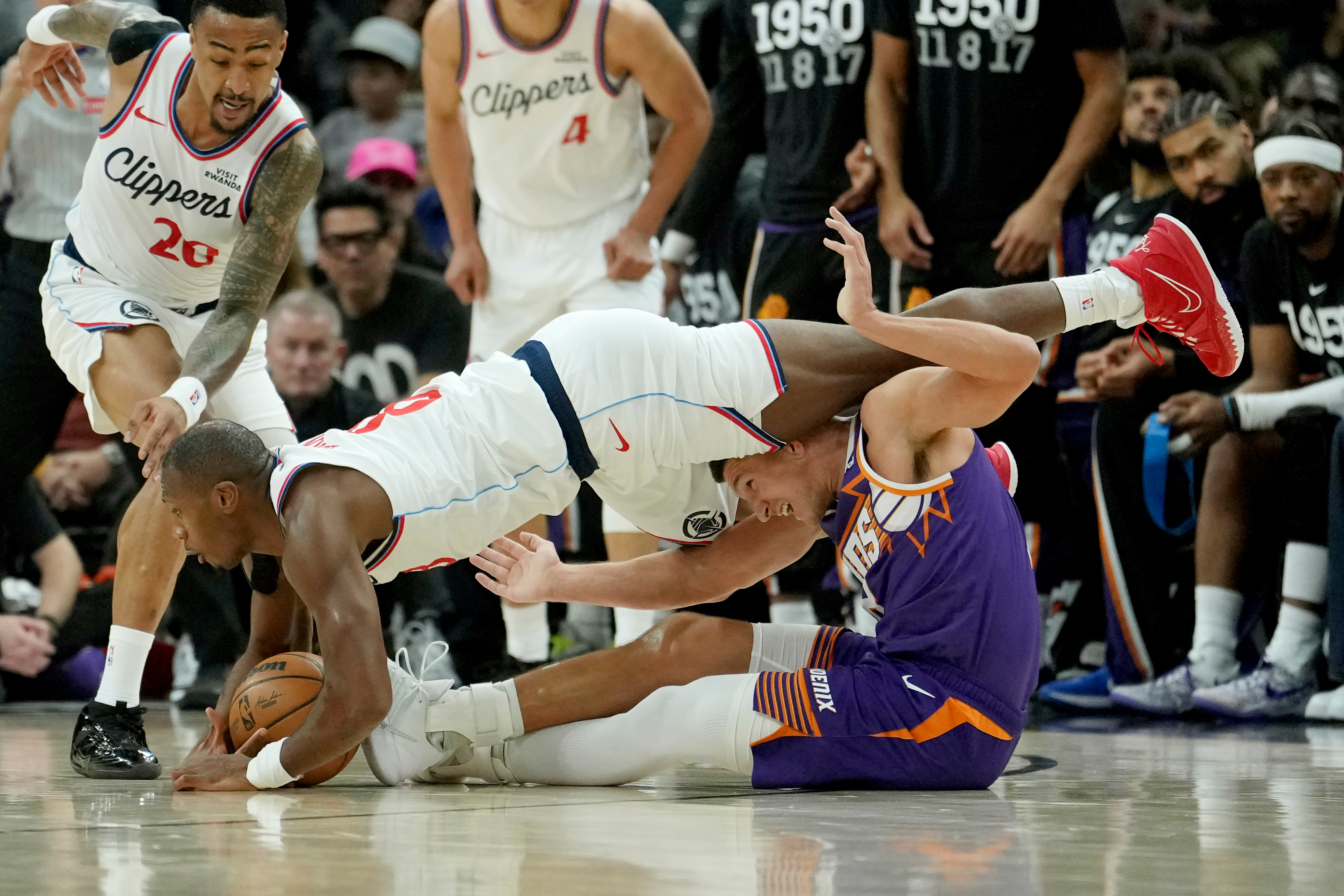 Clippers guard Kris Dunn, left, battles with Phoenix Suns guard...