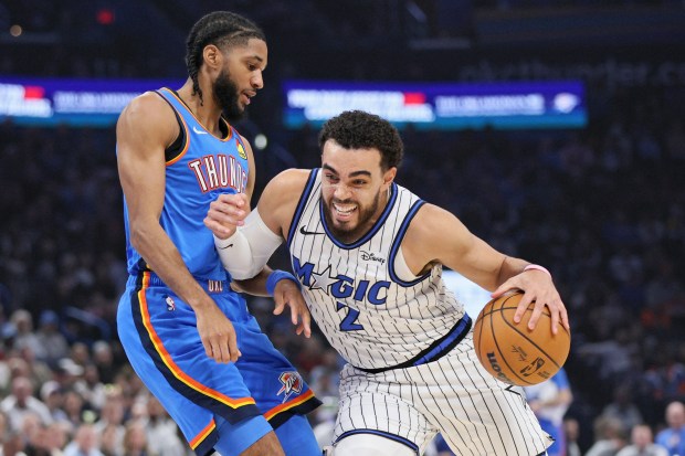 Orlando Magic guard Tyus Jones (2) drives against Oklahoma City Thunder guard Isaiah Joe, left, during the first half of an NBA game on Tuesday, Feb. 3, 2026, in Oklahoma City. (AP Photo/Nate Billings)