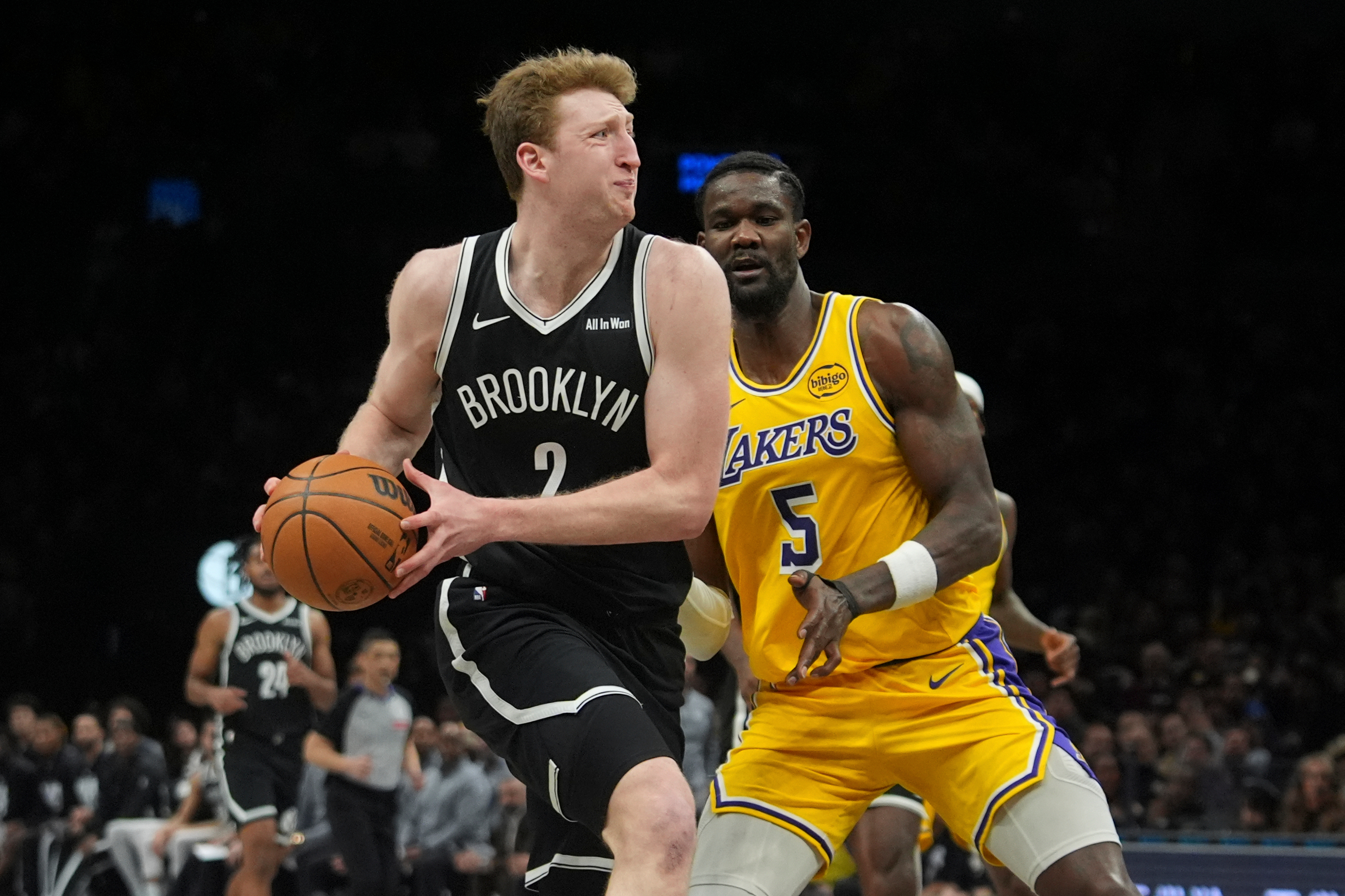 The Brooklyn Nets’ Danny Wolf drives past Lakers center Deandre...