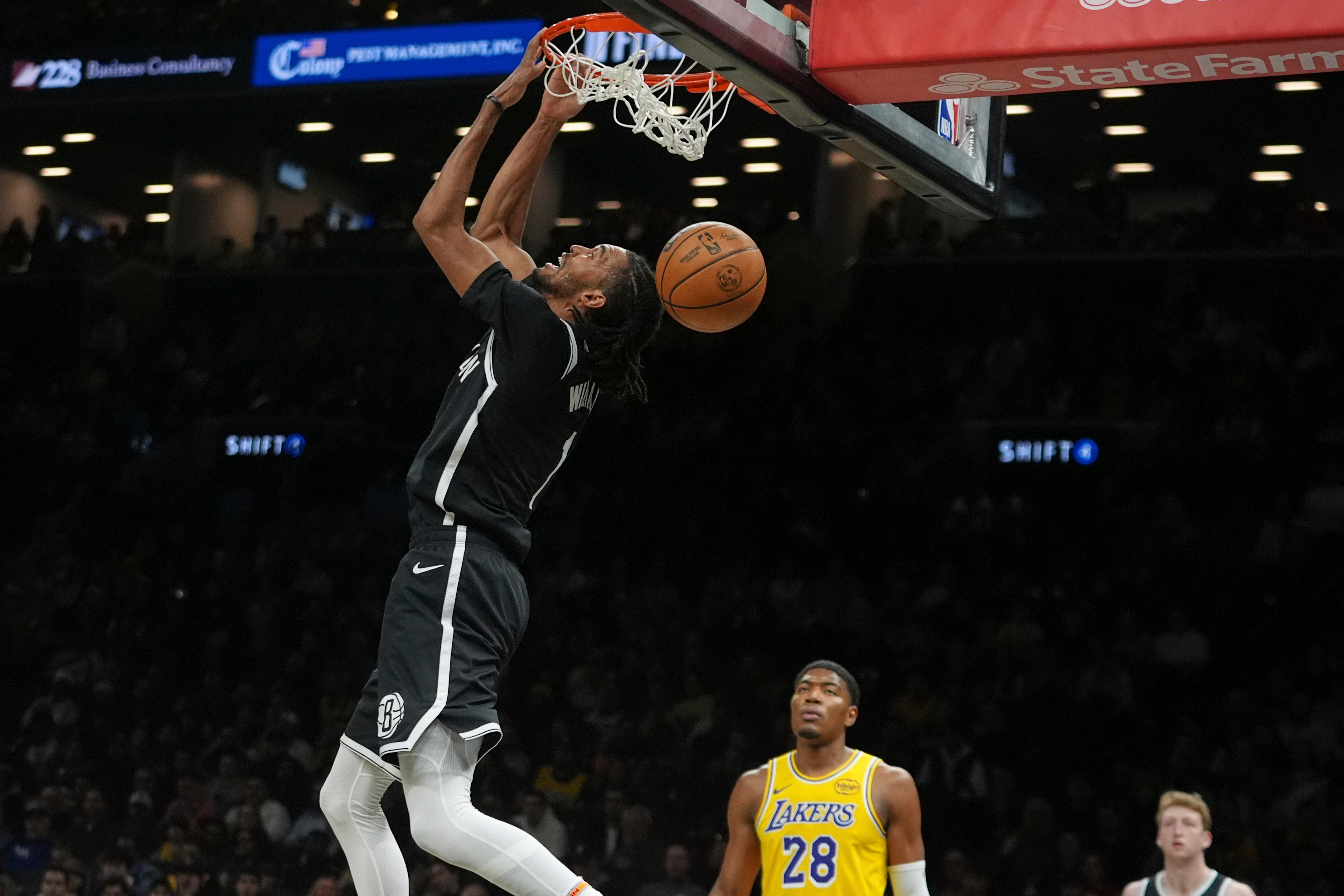 The Brooklyn Nets’ Ziaire Williams dunks in front of Lakers...