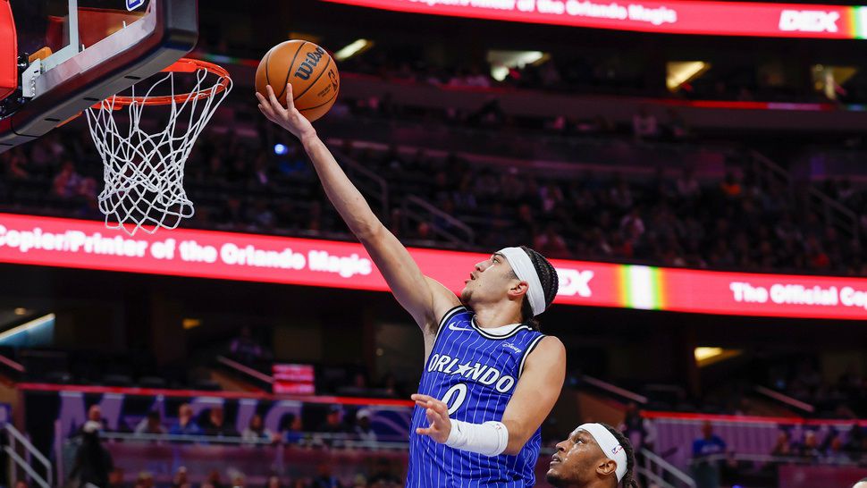 Orlando Magic guard Anthony Black (0) lays up the ball over Milwaukee Bucks center Myles Turner, center right, during the second half of an NBA basketball game Monday, Feb. 9, 2026, in Orlando, Fla. (AP Photo/Kevin Kolczynski)