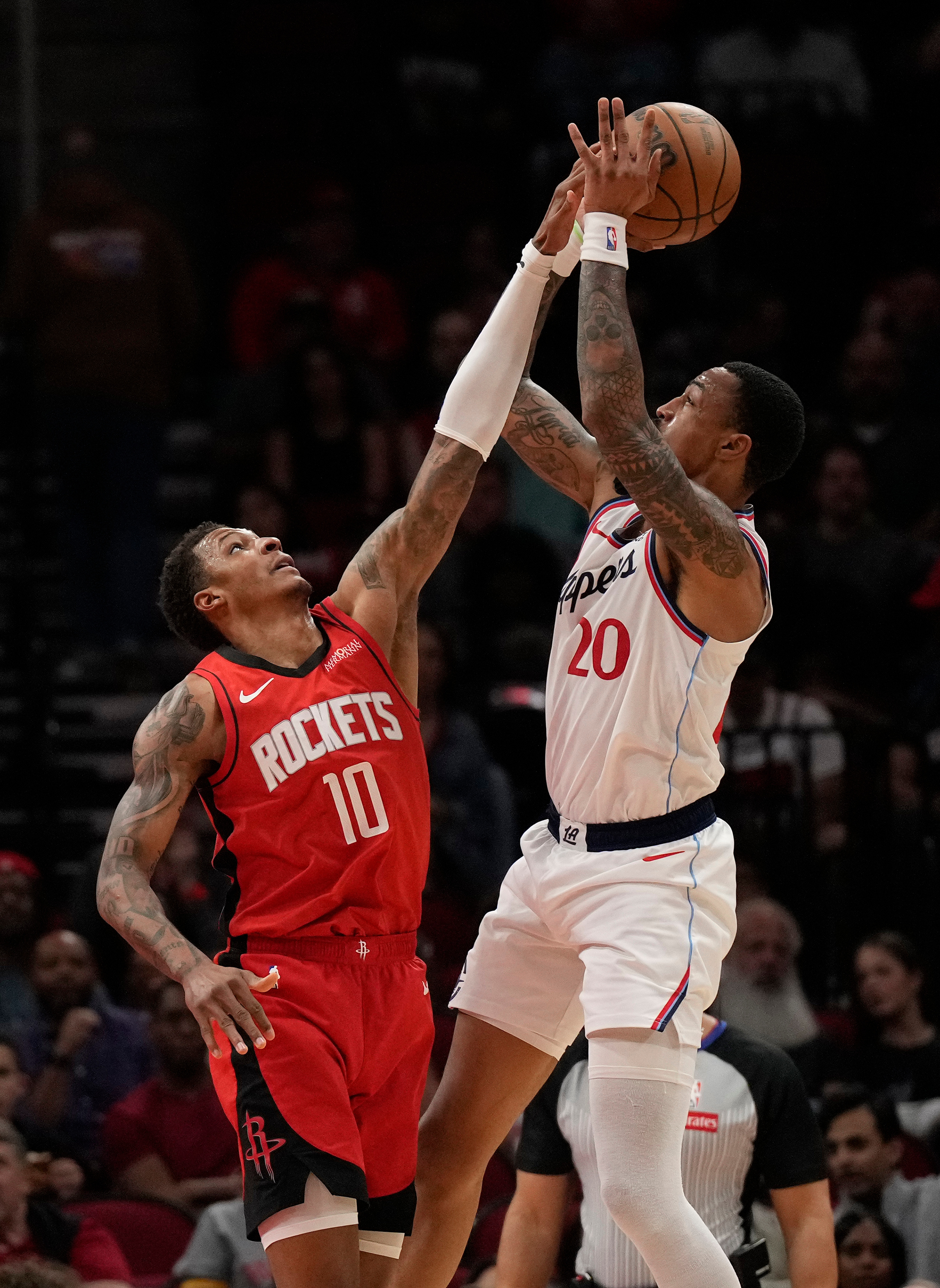 Houston Rockets forward Jabari Smith Jr., left, defends as Clippers...