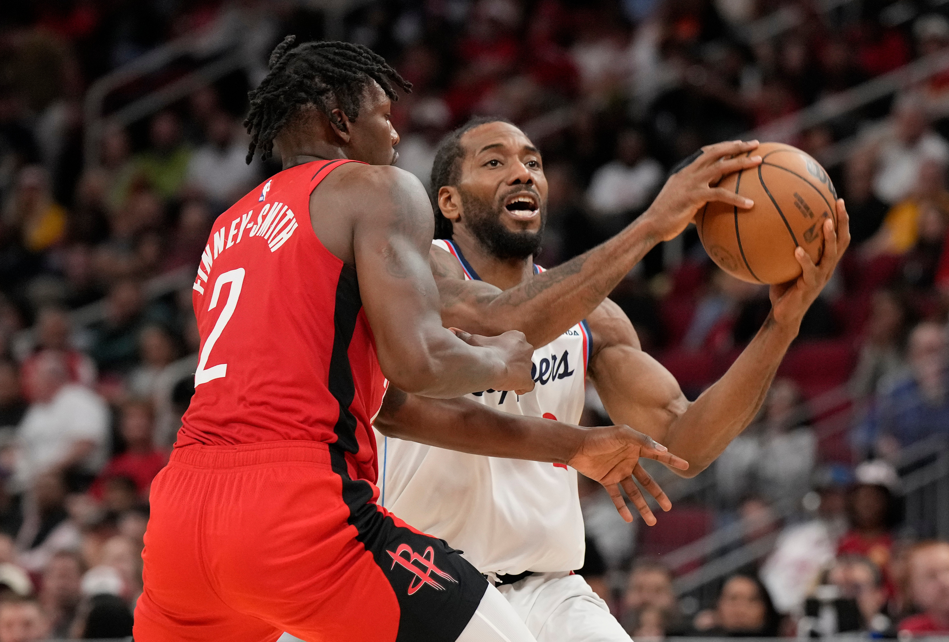 Clippers forward Kawhi Leonard looks to pass the ball as...