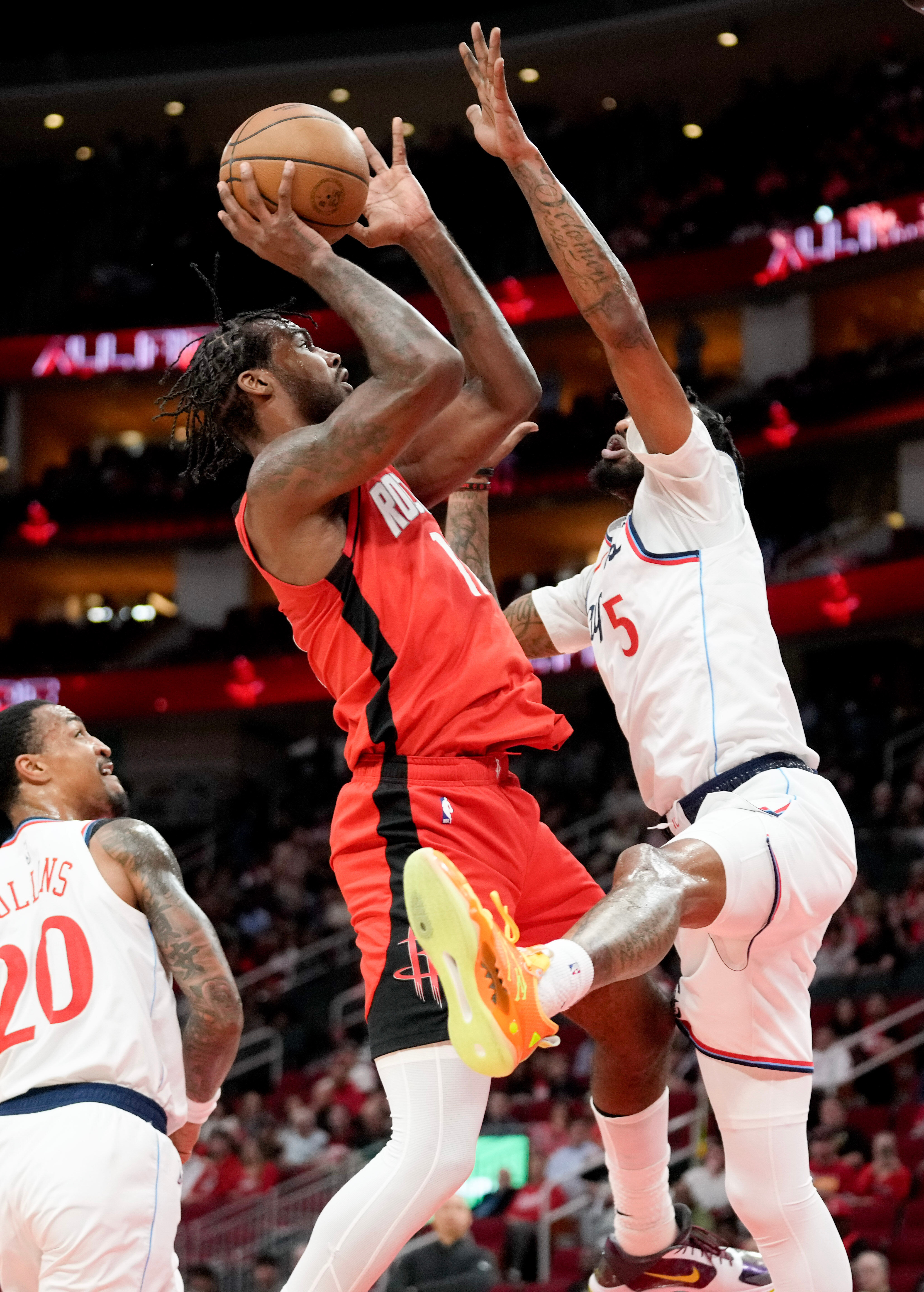 Houston Rockets forward Tari Eason, left, shoots as Clippers forward...
