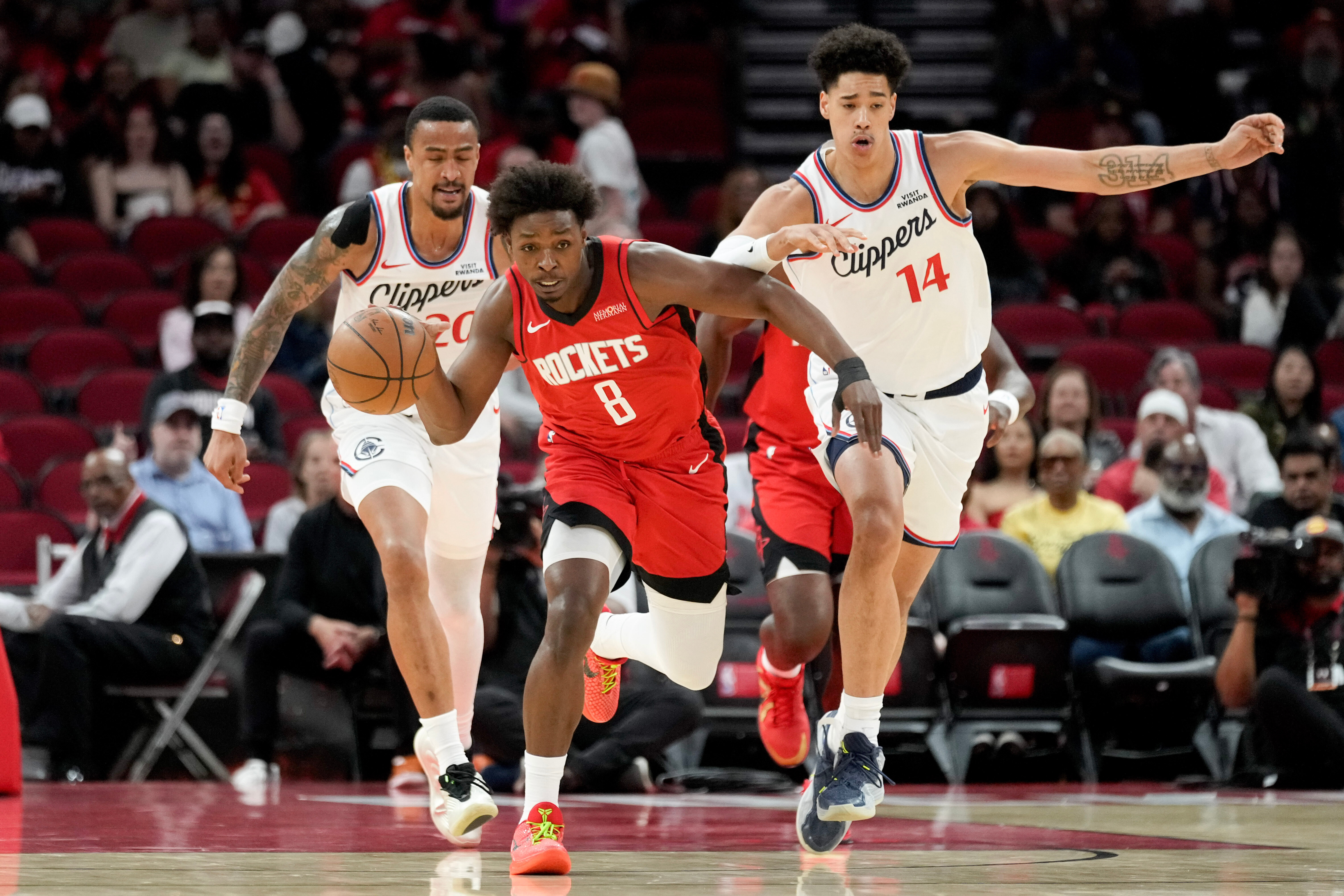 Houston Rockets forward Jae’sean Tate pushes the ball up the...