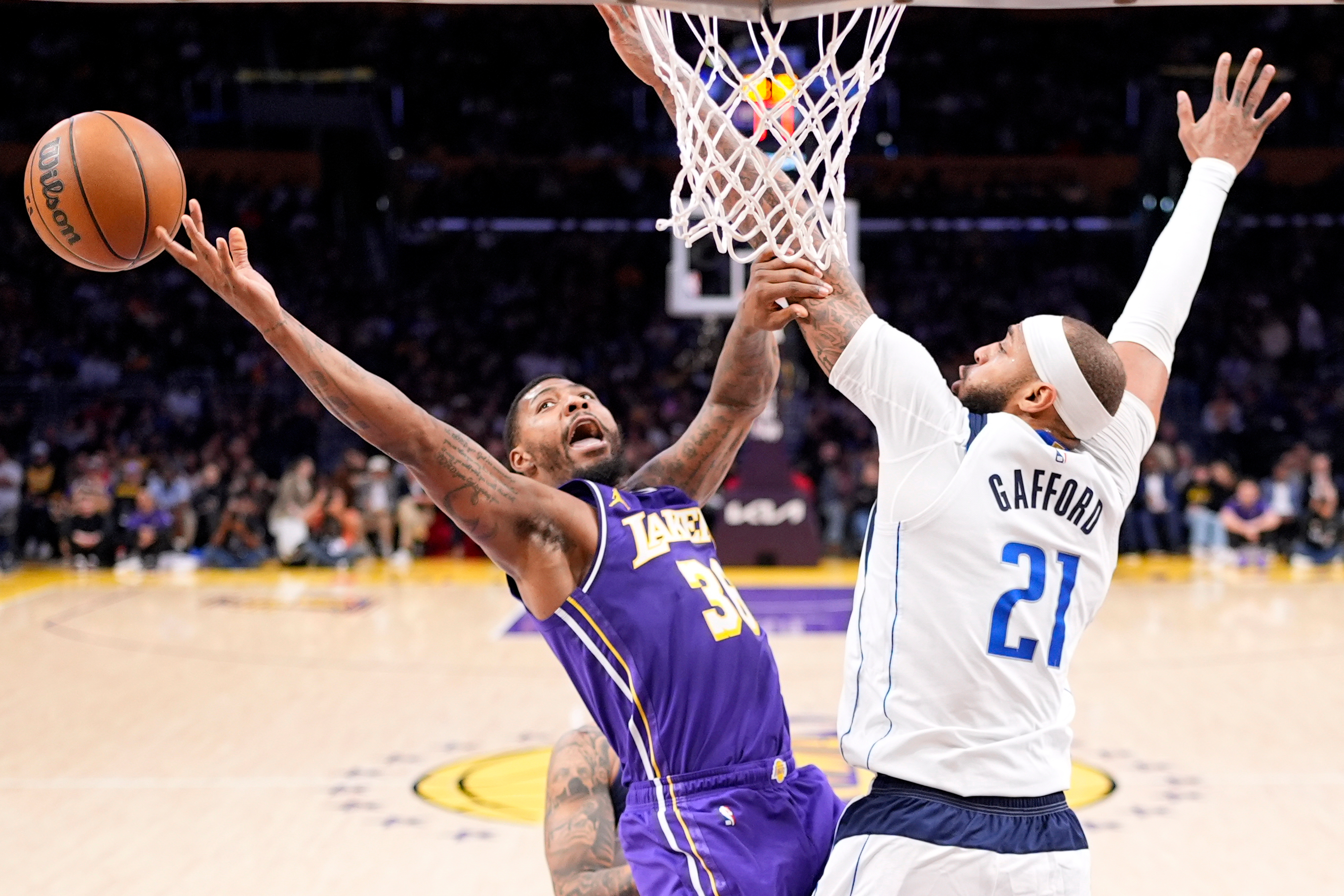 Lakers guard Marcus Smart, left, shoots as Dallas Mavericks forward...