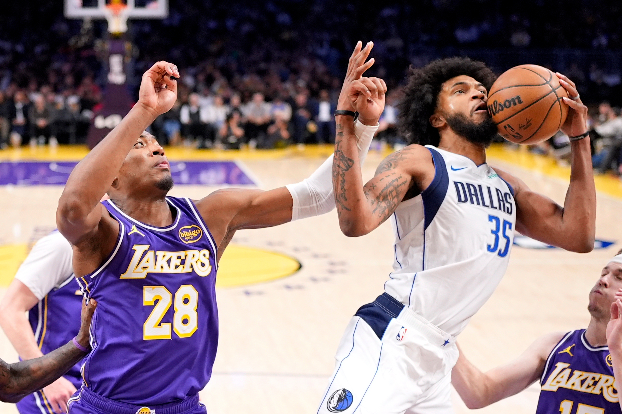 Dallas Mavericks forward Marvin Bagley III, right, grabs a rebound...
