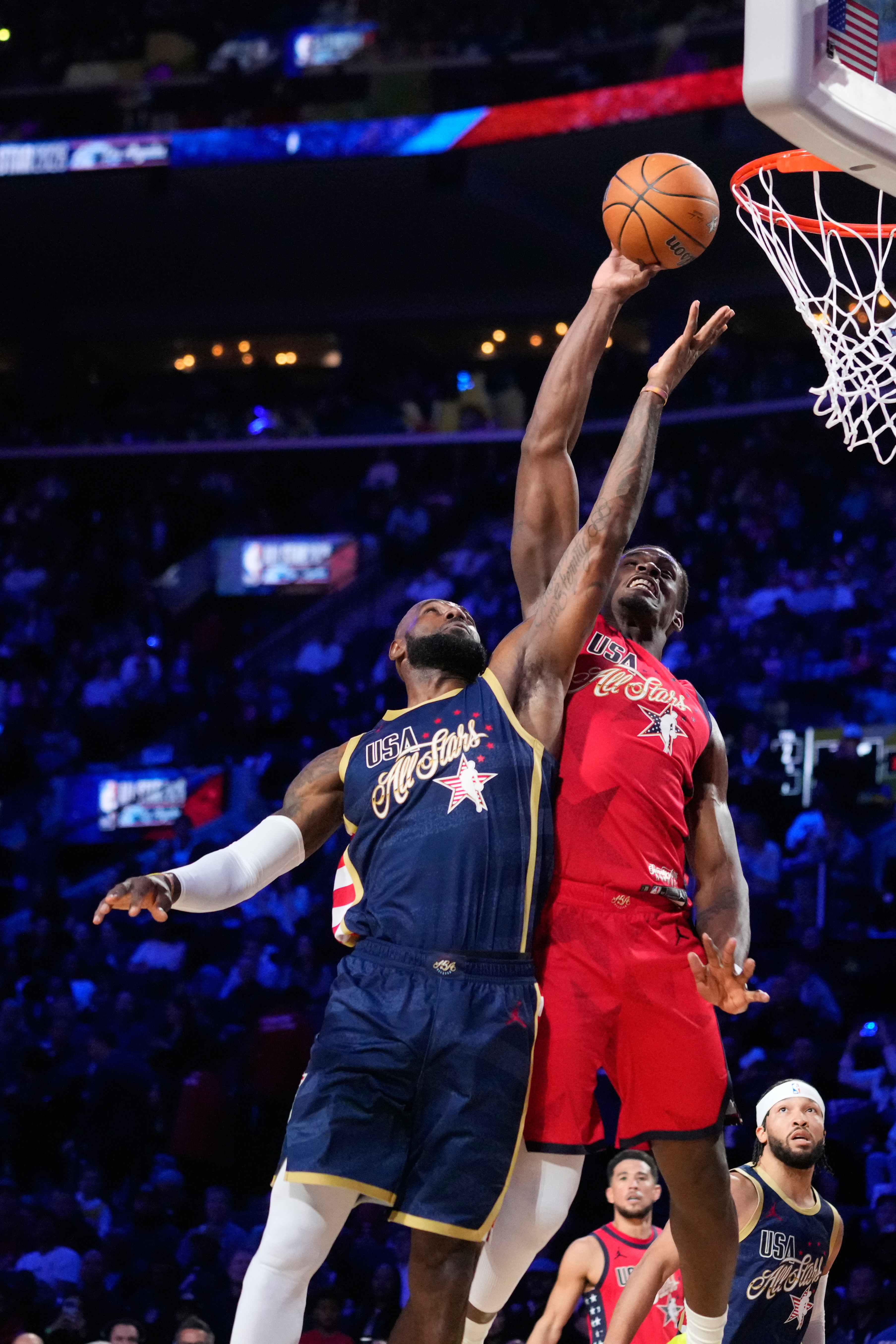 USA Stripes forward LeBron James, left, vies for a rebound...