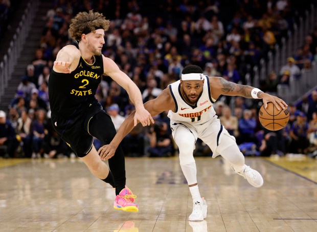 Nuggets forward/guard Bruce Brown (11) controls the ball against Warriors guard Brandin Podziemski (2) during the second half of a game Sunday in San Francisco. (AP Photo/Kelley L Cox)