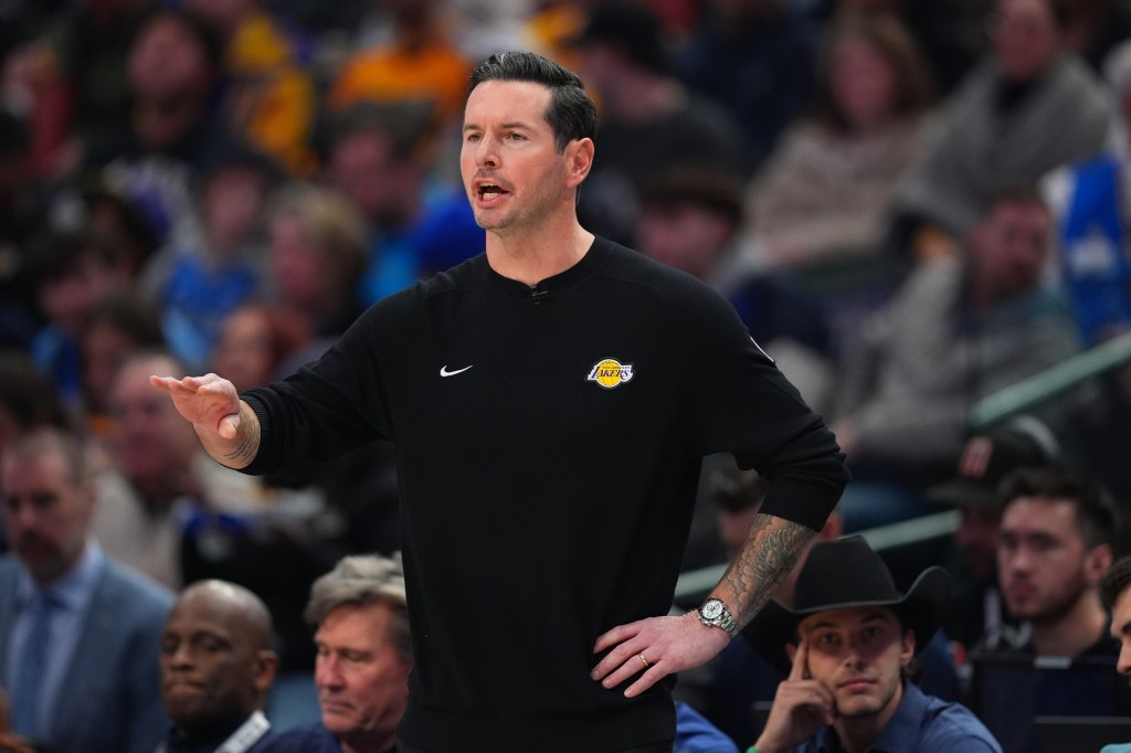 Los Angeles Lakers head coach JJ Redick talking to his team during an NBA game.