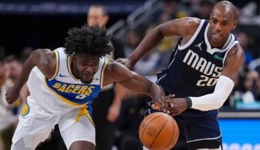 Indiana Pacers forward Jarace Walker (5) and Dallas Mavericks forward Khris Middleton (20) go for a loose ball during the first half of an NBA basketball game in Indianapolis, Sunday, Feb. 22, 2026. (AP Photo/Michael Conroy)