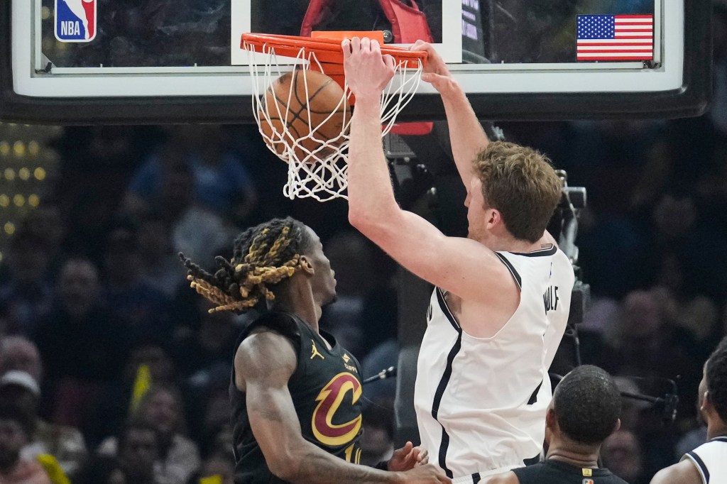 Brooklyn Nets forward Danny Wolf (2) dunks next to Cleveland Cavaliers guard Keon Ellis, left, in the first half of an NBA basketball game in Cleveland, Thursday, Feb. 19, 2026. 