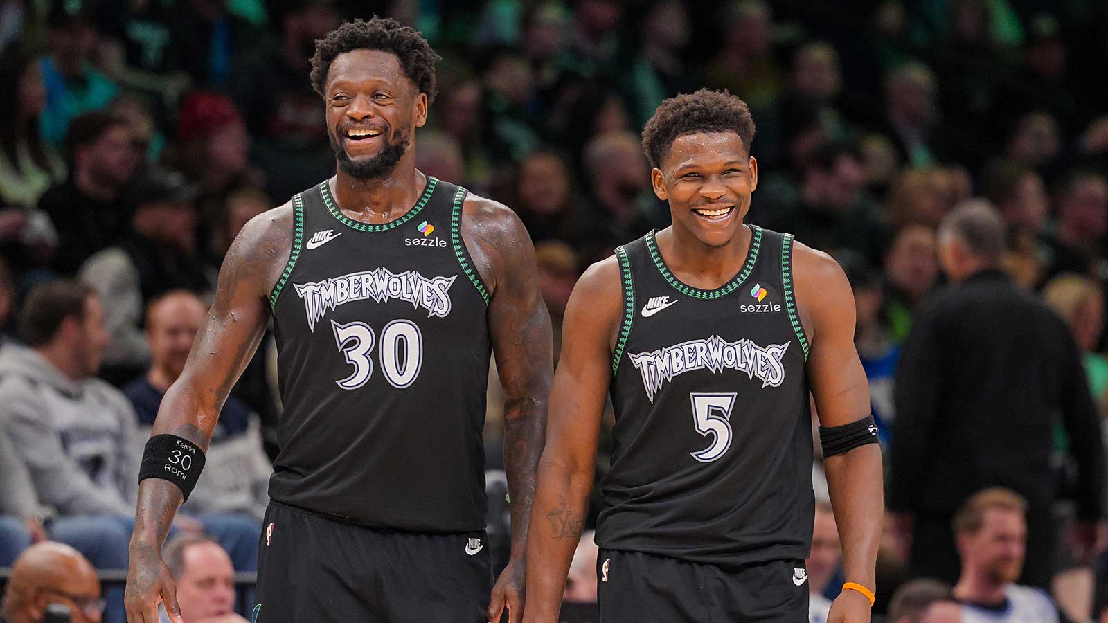 Minnesota Timberwolves forward Julius Randle (30) and guard Anthony Edwards (5) laugh after a timeout against the Atlanta Hawks in the fourth quarter at Target Center.