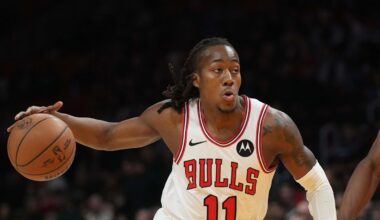 Jan 31, 2026; Miami, Florida, USA;  Chicago Bulls guard Ayo Dosunmu (11) drives to the basket as Miami Heat center Bam Adebayo (13) defends during the first half at Kaseya Center. Mandatory Credit: Jim Rassol-Imagn Images
