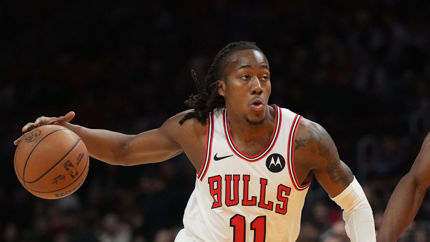 Jan 31, 2026; Miami, Florida, USA;  Chicago Bulls guard Ayo Dosunmu (11) drives to the basket as Miami Heat center Bam Adebayo (13) defends during the first half at Kaseya Center. Mandatory Credit: Jim Rassol-Imagn Images