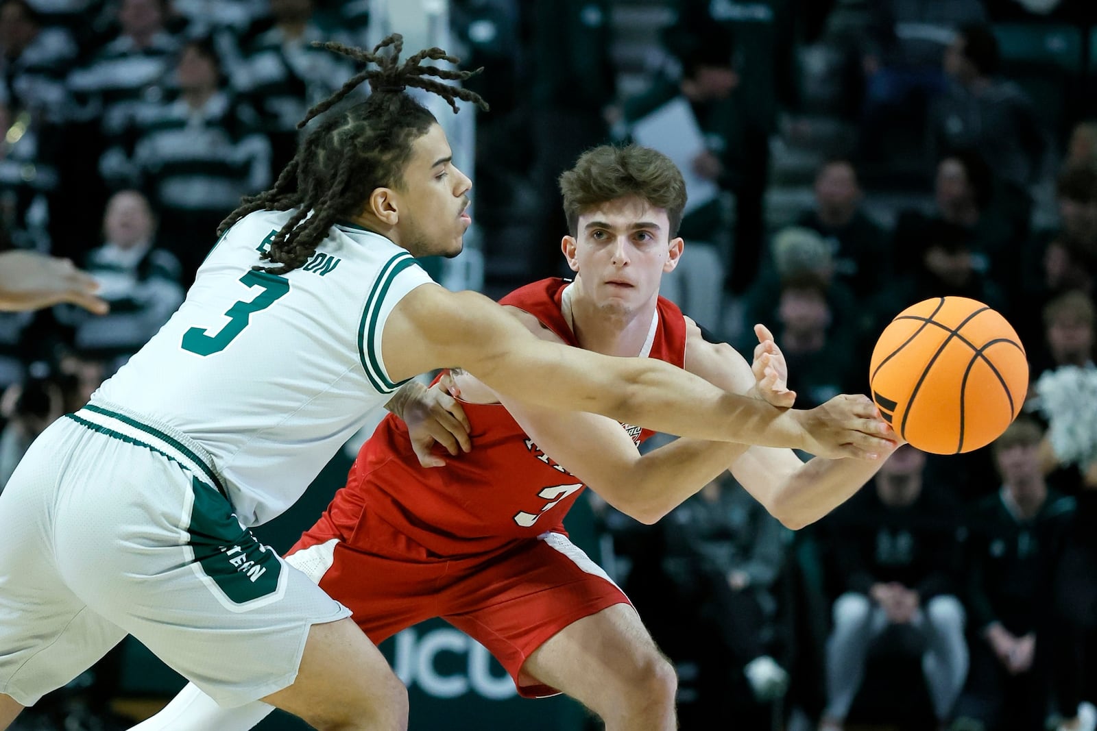 Eastern Michigan guard Mehki Ellison, left, fouls Miami (OH) guard Luke Skaljac, right, during the first half of an NCAA college basketball game, Tuesday, Feb. 24, 2026, in Ypsilanti, Mich. (AP Photo/Duane Burleson)