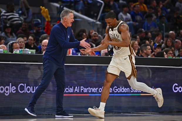 Golden State Warriors' De'Anthony Melton (8) gets a big congratulatory hand shake from Golden State Warriors head coach Steve Kerr in the fourth quarter of their NBA game at Chase Center in San Francisco, Calif., on Saturday, Jan. 17, 2026. The Golden State Warriors defeated the Charlotte Hornets 136-116. (Jose Carlos Fajardo/Bay Area News Group)