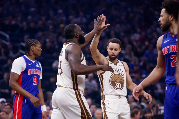Golden State Warriors' Draymond Green (23) and Golden State Warriors' Stephen Curry (30) high five against Detroit Pistons' Ausar Thompson (9) and Detroit Pistons' Cade Cunningham (2) in the first quarter at the Chase Center in San Francisco, Calif., on Friday, Jan. 30, 2026. (Shae Hammond/Bay Area News Group)
