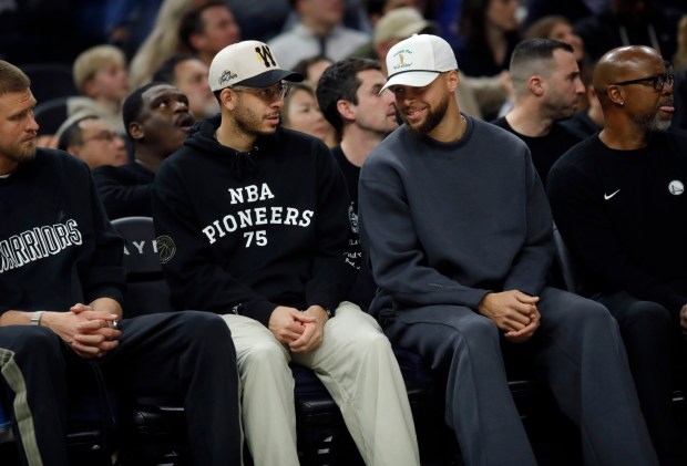 Golden State Warriors' Stephen Curry #30 and his brother Seth Curry, #31 left, sit on the bench in the third quarter of their NBA game against the Memphis Grizzlies at the Chase Center in San Francisco, Calif., on Monday, Feb. 9, 2026. (Jane Tyska/Bay Area News Group)
