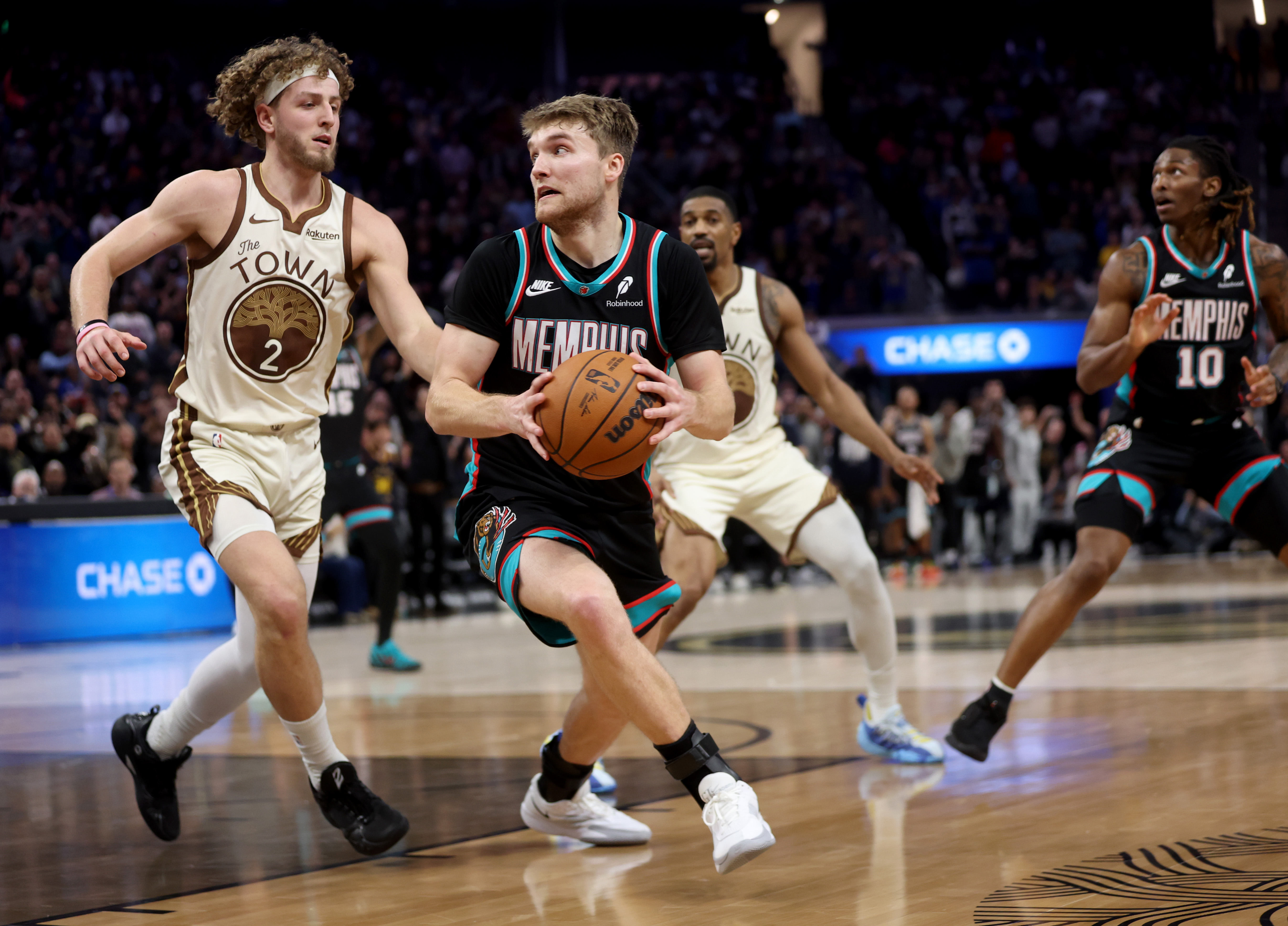 Memphis Grizzlies’ Cam Spencer #24 is guarded by Golden State...