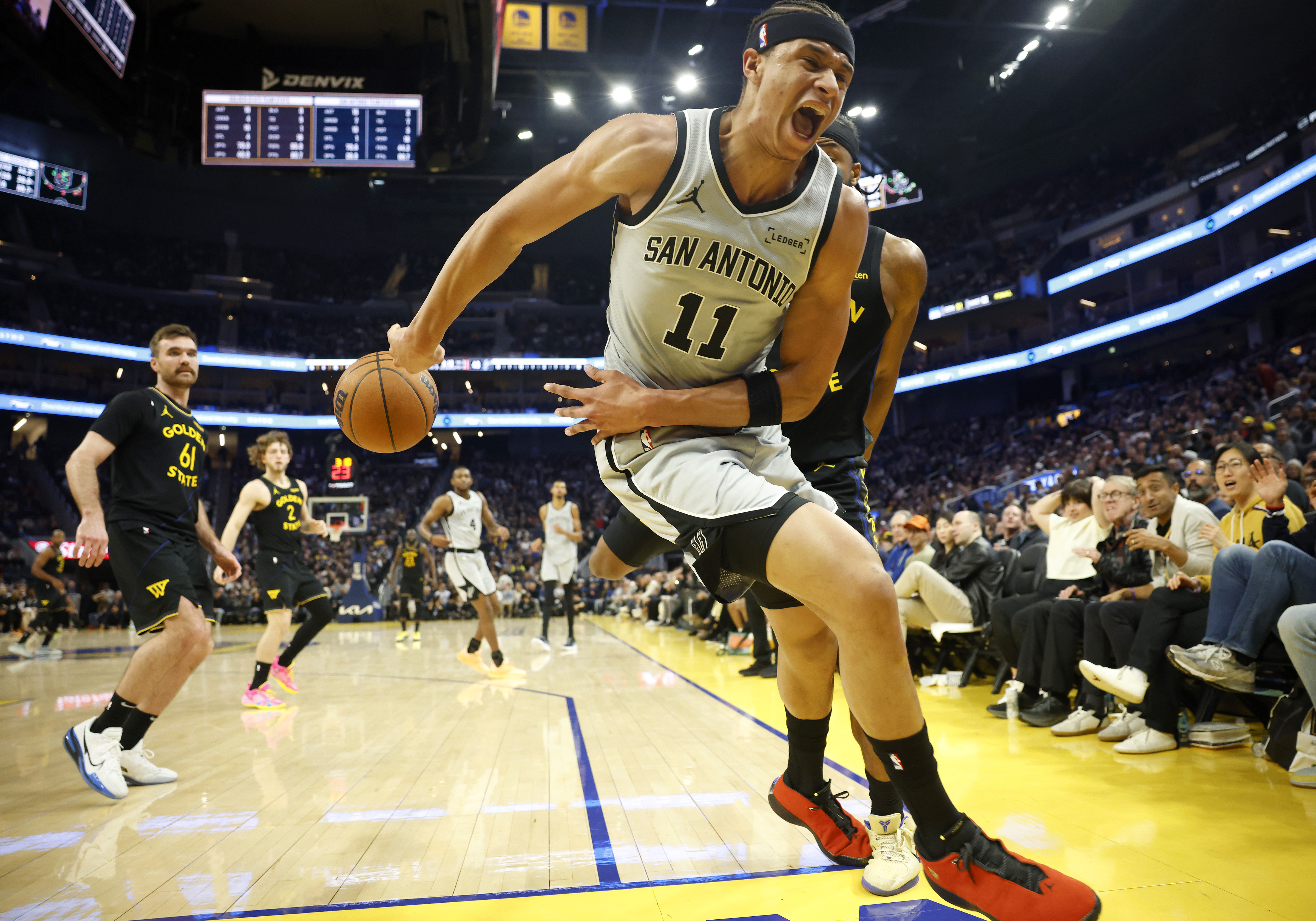 San Antonio Spurs' Carter Bryant (11) tries to save a...