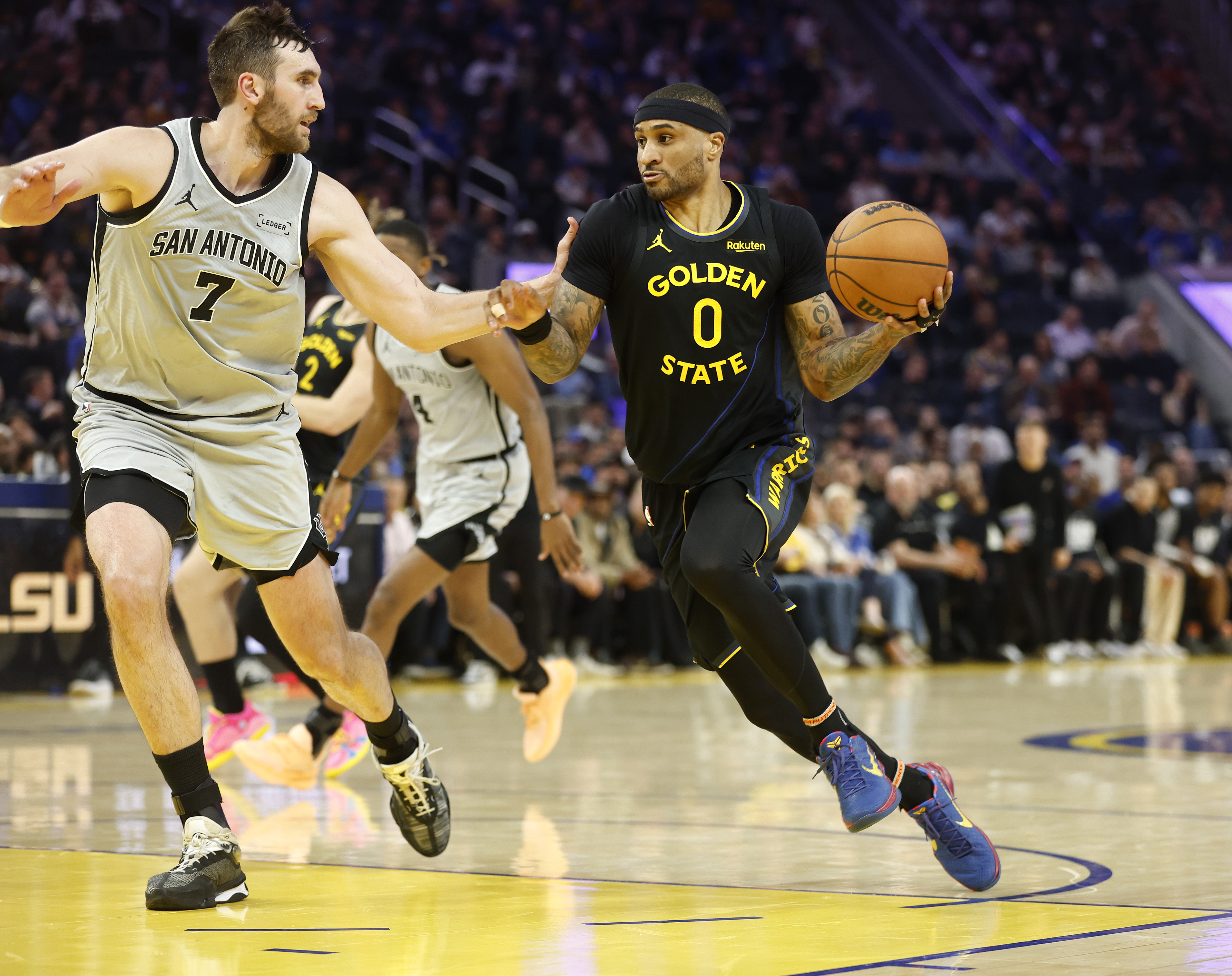 Golden State Warriors' Gary Payton II (0) heads to the...