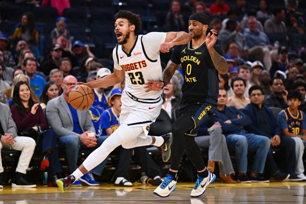 Golden State Warriors' Gary Payton II (0) fouls Denver Nuggets' Cam Johnson (23) in the second quarter of their NBA game at Chase Center in San Francisco, Calif., on Sunday, Feb. 22, 2026. (Jose Carlos Fajardo/Bay Area News Group)