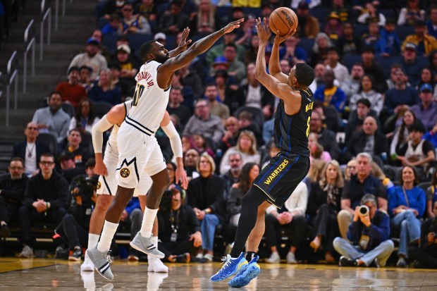 Golden State Warriors' De'Anthony Melton (8) shoots against Denver Nuggets' Tim Hardaway Jr. (10) in the second quarter of their NBA game at Chase Center in San Francisco, Calif., on Sunday, Feb. 22, 2026. (Jose Carlos Fajardo/Bay Area News Group)