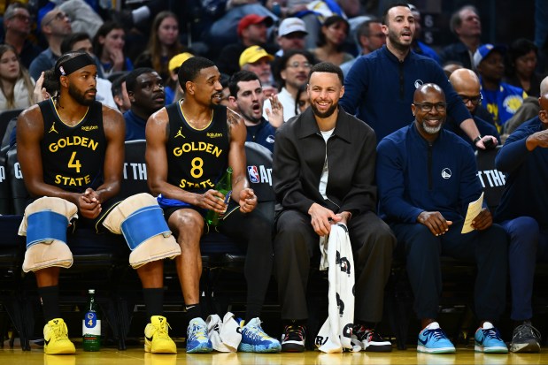 Golden State Warriors' Stephen Curry (30) wears street clothes while on the bench in the second quarter of their NBA game at Chase Center in San Francisco, Calif., on Sunday, Feb. 22, 2026. (Jose Carlos Fajardo/Bay Area News Group)