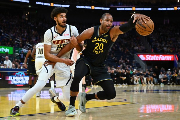 Golden State Warriors' Al Horford (20) drives against Denver Nuggets' Cam Johnson (23) in the third quarter of their NBA game at Chase Center in San Francisco, Calif., on Sunday, Feb. 22, 2026. The Golden State Warriors defeated the Denver Nuggets 128-117. (Jose Carlos Fajardo/Bay Area News Group)