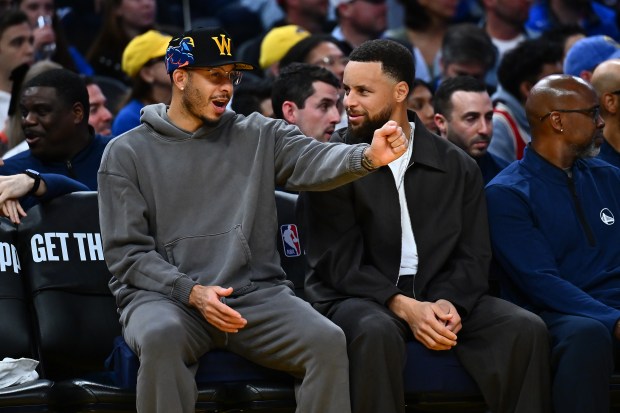 Golden State Warriors' Seth Curry (31), left, chats with his brother Stephen Curry (30) while sitting on the bench in the third quarter of their NBA game at Chase Center in San Francisco, Calif., on Sunday, Feb. 22, 2026. The Golden State Warriors defeated the Denver Nuggets 128-117. (Jose Carlos Fajardo/Bay Area News Group)