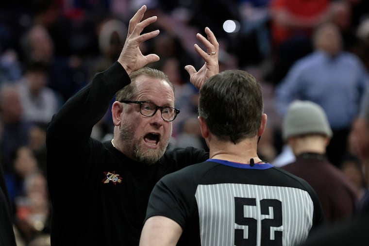 Sixers coach Nick Nurse makes a point while speaking with an official during the New York Knicks vs. Philadelphia 76ers (Sixers) NBA game at Xfinity Mobile Arena in Philadelphia on Wednesday, Feb. 11, 2026.