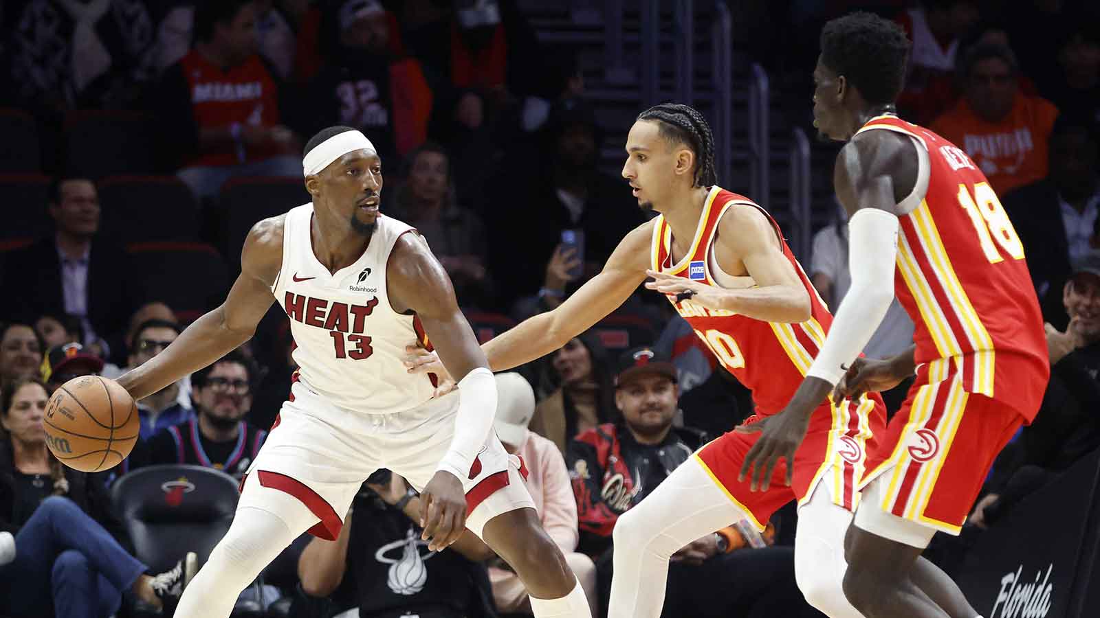 Atlanta Hawks forward Zaccharie Risacher (10) and forward Mouhamed Gueye (18) defend Miami Heat center Bam Adebayo (13) during the second half at Kaseya Center. 