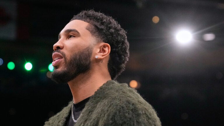 Boston Celtics forward Jayson Tatum stands next to the bench during a time out in the first half of an NBA basketball game against the Chicago Bulls, Wednesday, Feb. 11, 2026, in Boston.