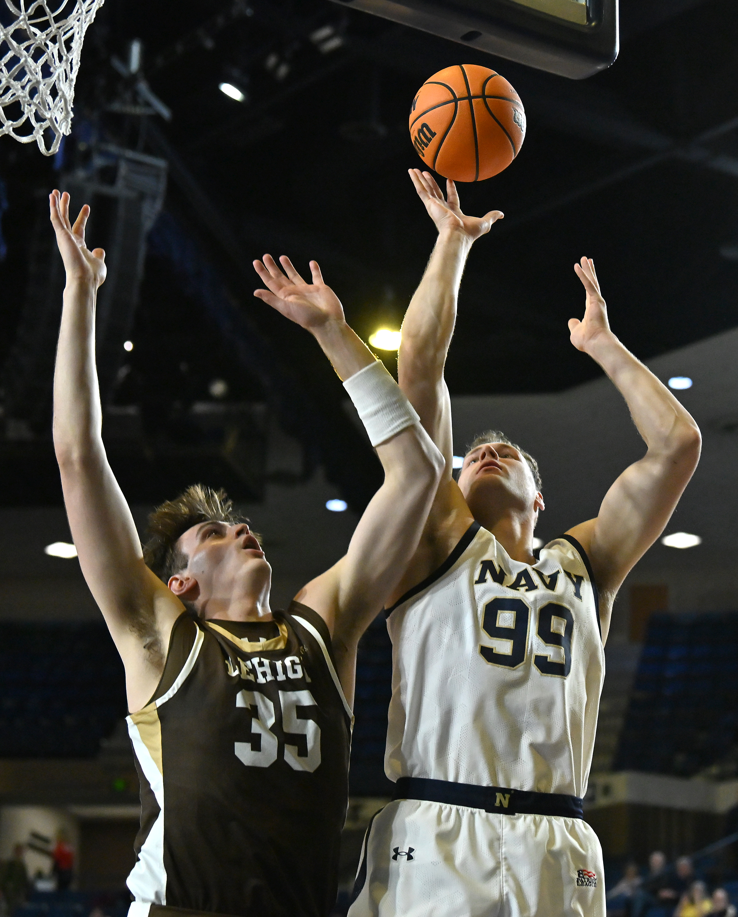 Navy Midshipmen center Aidan Kehoe #99 puts up a shot over Lehigh Mountain Hawks forward Hank Alvey #35 during the first half. The Navy Midshipmen host the Lehigh Mountain Hawks in men's NCAA basketball. (Paul W. Gillespie/Staff)