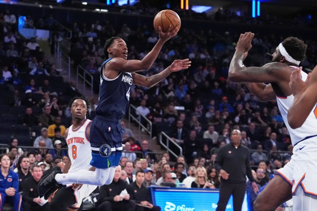 The Timberwolves' Rob Dillingham drives past the Knicks' OG Anunoby during a preseason game Oct. 9, 2025, in New York. (AP Photo/Frank Franklin II)