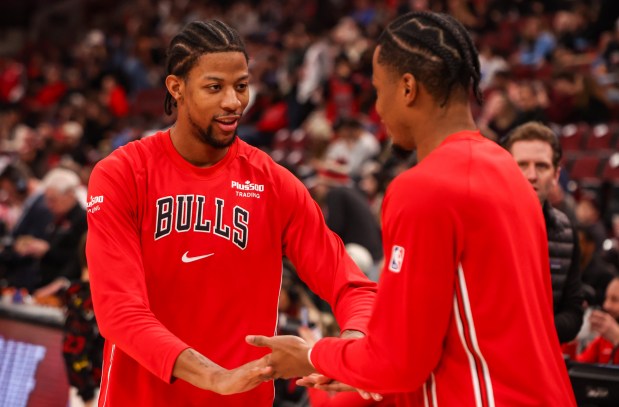 The Bulls' Dalen Terry, left, and Isaac Okoro during warmups before a game against the 76ers on Dec. 26, 2025, at the United Center. (Dominic Di Palermo/Chicago Tribune)