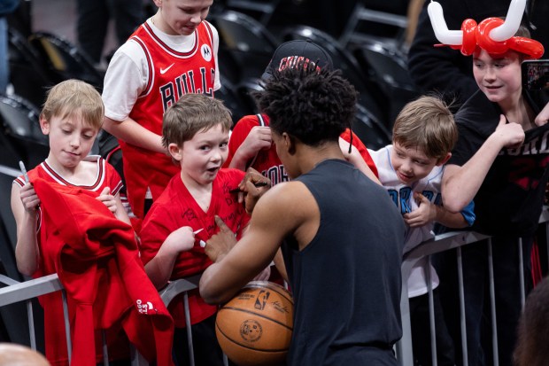 Chicago Bulls guard Collin Sexton signs autographs for young fans ahead of a game against the Portland Trail Blazers at the United Center in Chicago on Feb. 26, 2026. (Josh Boland/Chicago Tribune)