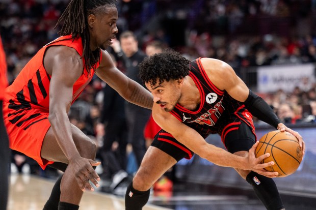 Chicago Bulls guard Tre Jones carries the ball against Portland Trail Blazers guard Jrue Holiday in the first half of a game against the Portland Trail Blazers at the United Center in Chicago on Feb. 26, 2026. (Josh Boland/Chicago Tribune)